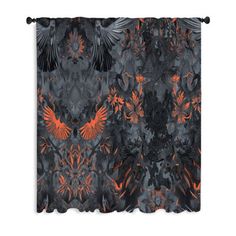 an orange and black curtain hanging on a wall