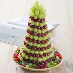 a fruit christmas tree is displayed on a plate