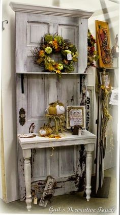 an old cabinet is decorated with wreaths and other decorations for fall or thanksgiving time