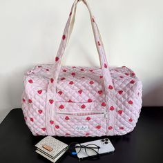 Introducing the Strawberry Large Duffel Bag – a spacious carry-all with a convenient zippable front pocket, designed to make a statement wherever life takes you.    The quilted exterior features a beautiful strawberry-themed pattern, complemented by a classy pink gingham interior.     Perfect for extended trips, weekend getaways, or as a chic gym companion, the Strawberry Large Duffel Bag effortlessly combines fashion and functionality.   Size: 20" x 12" x 11" Gingham Interior, Handbags Aesthetic, Chic Gym, Mini Makeup Bag, Large Makeup Bag, Strawberry Decorations, Dorm Inspo, Tool Bags