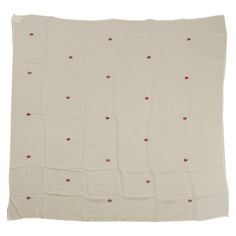 a white blanket with red dots on it