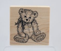 a wooden stamp with a teddy bear on it