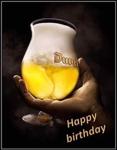 a person holding a beer mug with the words happy birthday written on it