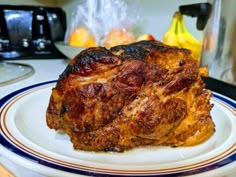 a piece of meat sitting on top of a white plate