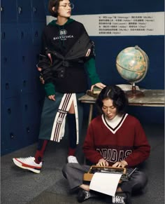 two young people sitting on the floor in front of lockers