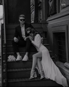 a man and woman sitting on the steps next to each other