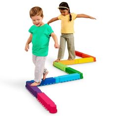 two young children playing with colorful blocks in the shape of an e - shaped arrow