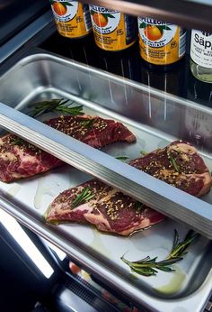 three raw meats are being prepared in the refrigerator