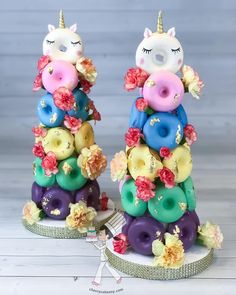 two fake doughnuts in the shape of unicorns with donuts on them