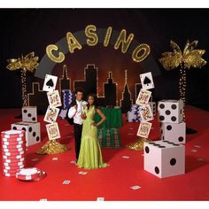 two people standing in front of casino themed backdrop