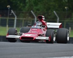 a man driving a racing car on a race track