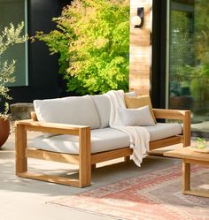 a couch sitting on top of a wooden patio