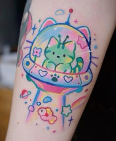 a colorful tattoo on the leg of a person with a cat in a space ship