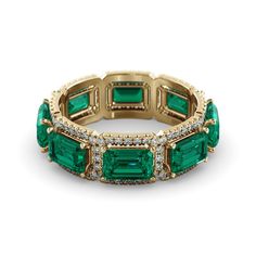 an emerald and diamond ring with three rows of diamonds on each side, set in yellow gold