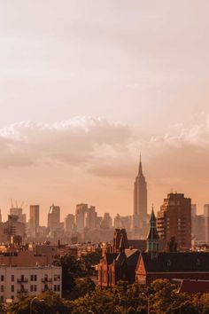 the city skyline is shown with tall buildings and skyscrapers in the background at sunset