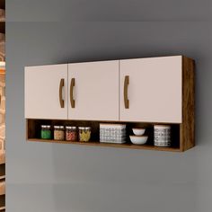 a wall mounted cabinet with two doors and some bowls on the bottom shelf next to it