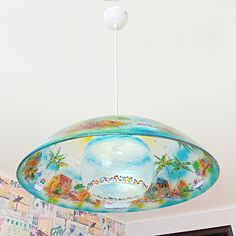 a ceiling light hanging from the ceiling in a room with colorful wallpaper on it