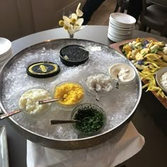 an assortment of food is being served on a platter in the middle of a table