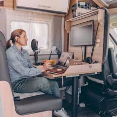 a woman sitting at a desk with a laptop