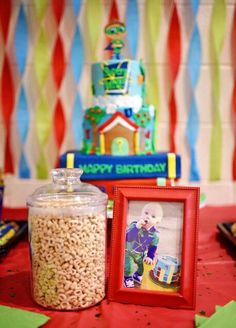 a birthday party with candy and candies on the table, including a photo frame