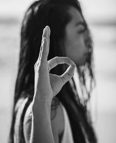 a woman making the peace sign with her fingers