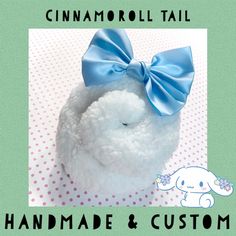 a white stuffed animal with a blue bow on it's head and the words, handmade & custom