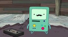 a cartoon character standing next to an old gameboy on the ground with a moustache