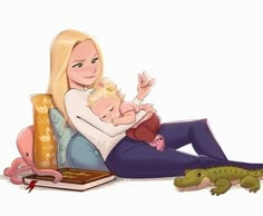 a woman holding a baby while sitting on top of a couch next to an alligator