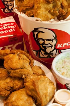 fried chicken and coleslaw are served in buckets next to ketchup