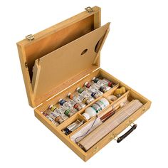 an open wooden box filled with lots of crafting supplies