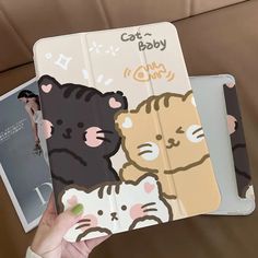 a person holding two ipad cases with cartoon animals on them, one has a cat and the other is a bear