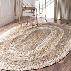 a round rug in the middle of a room with two stools on either side