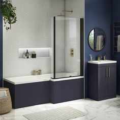 a modern bathroom with blue walls and white tile flooring, including a walk in shower