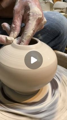 a person is making a pot on a potter's wheel