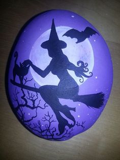 a painted rock with a witch on it