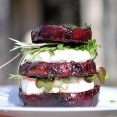 a white plate topped with two beets and cheese sandwiches