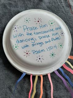 a paper plate with a poem written on it and streamers around the edge that says, praise him with the fanfare and dancing grace him with wings and faith