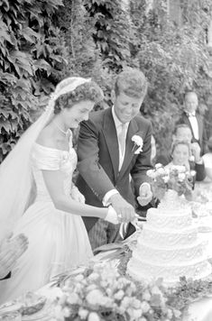 a bride and groom cutting their wedding cake