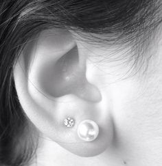 a woman with an ear piercing in black and white