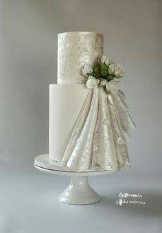 a white wedding cake with flowers on top