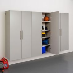 a room that has some cupboards and a basketball on the floor in it's corner