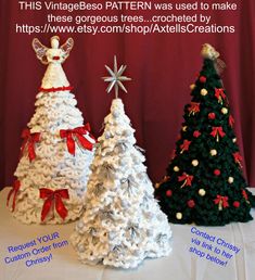 three crocheted christmas trees sitting on top of a white tablecloth covered table