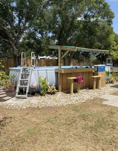 an outdoor hot tub in the middle of a yard with steps leading up to it