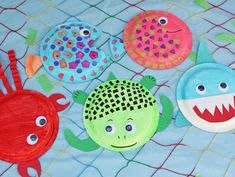 paper plates with fish and sea creatures painted on them