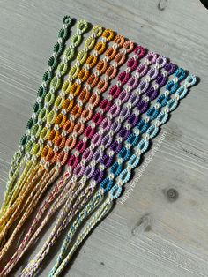 multicolored crocheted doily on wooden table