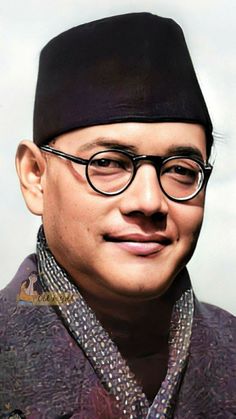 a man wearing glasses and a black hat