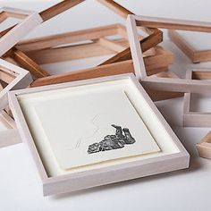 a group of wooden frames sitting on top of a white table next to each other