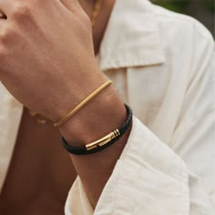 Featuring a clean and understated 18K gold barrel, this woven leather bracelet will add depth to your look by breaking up the metal. Its polished golden accents feature intricate clover detailing and a secure bayonet clasp for a comfortable fit. Wear it solo or stack it with your favourite gold rings for an instantly elevated look. ​​✓ 18K Gold & Leather✓ Water, Heat, Sweat Resistant✓ Hypoallergenic (No Green Skin)Model is 5'11 & Wears 7.5" Length. Men Gold And Leather Bracelet, Golden Bracelets For Men, Bracelet Stack Men, Boys Bracelets Gold, Bracelet Photography, Boy Jewelry, Bracelets Outfit, Boys Bracelets, Man Bracelet