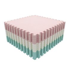 a stack of pink, green and white tiles on top of each other in different colors