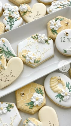 decorated cookies in the shape of honeycombs with names and date written on them